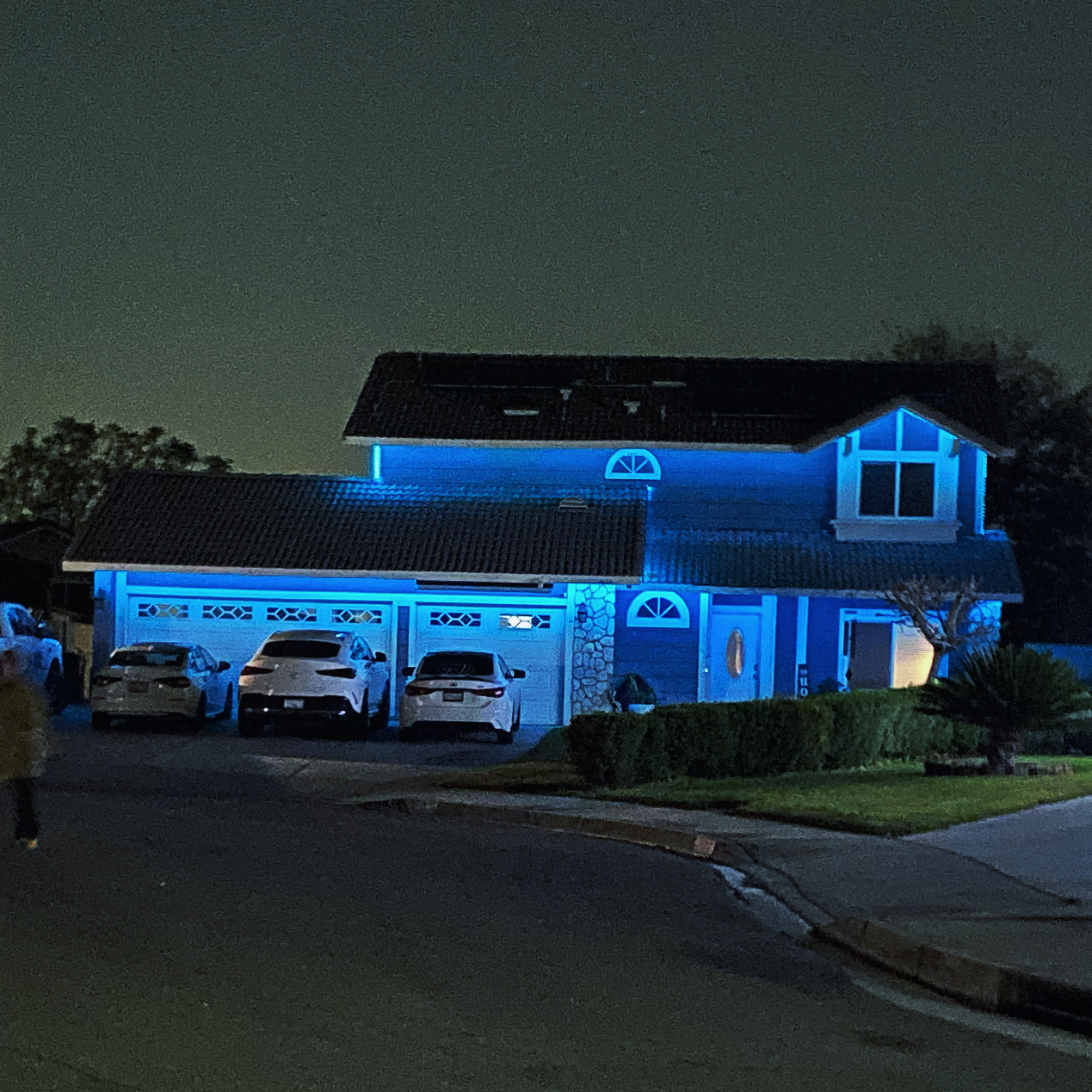 Home lit with bright blue permanent outdoor lights