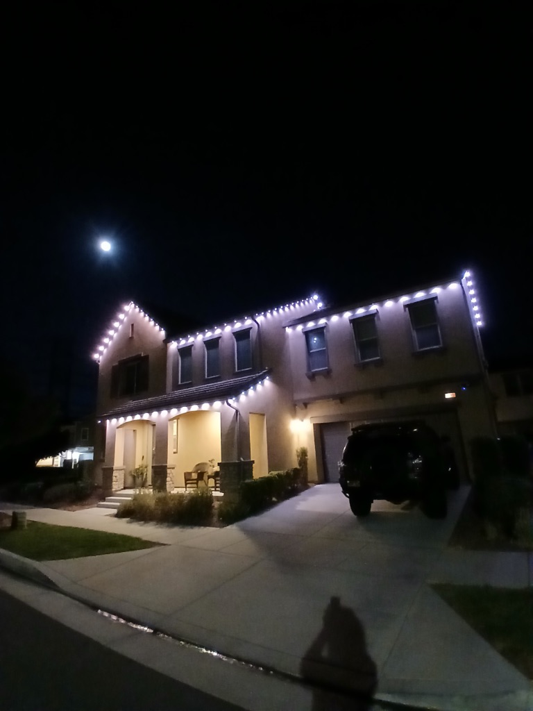 Warm white permanent lights with the moon visible