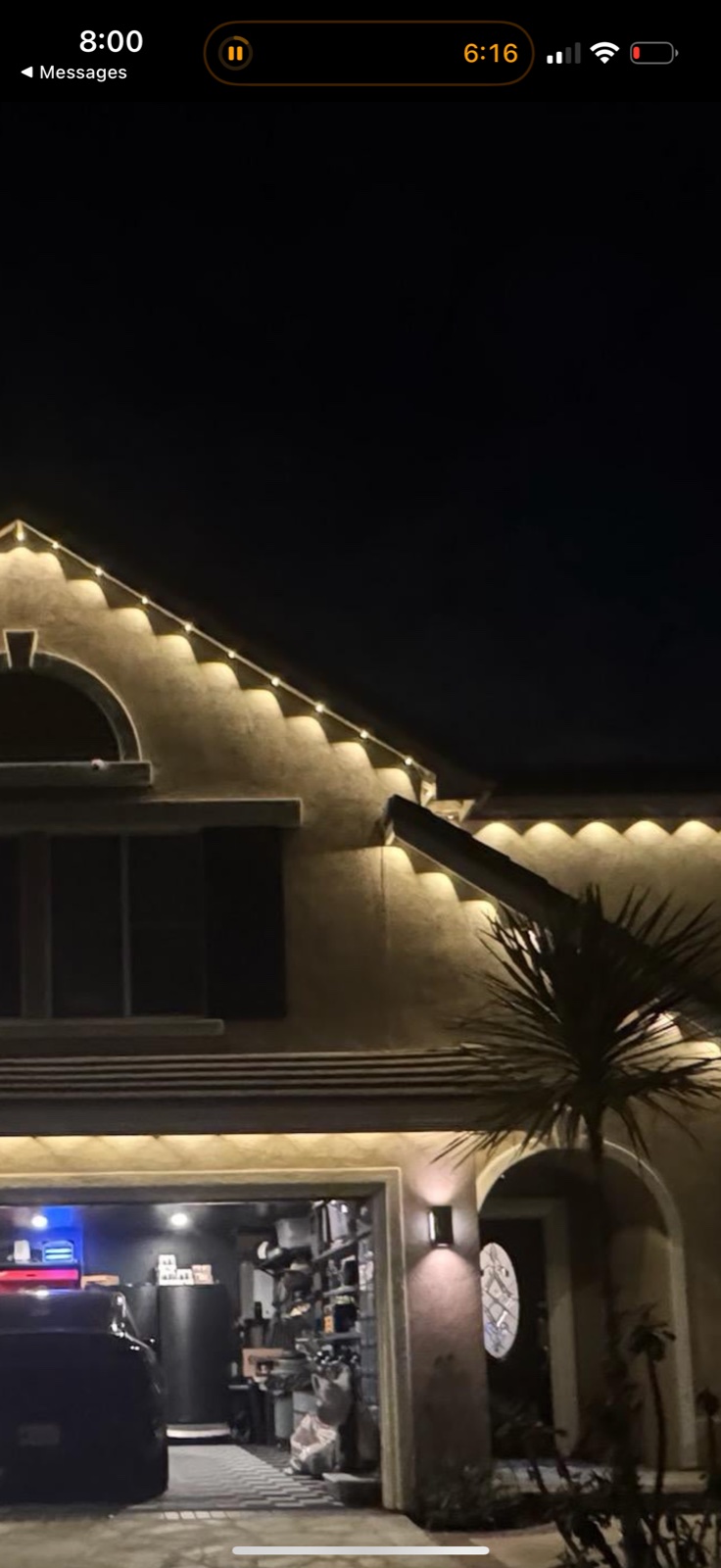 Real install photo showing multicolor permanent outdoor lights on a home